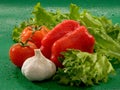 Vegetables - tomatoes, garlic, red bell pepper, lettuce leaves Royalty Free Stock Photo